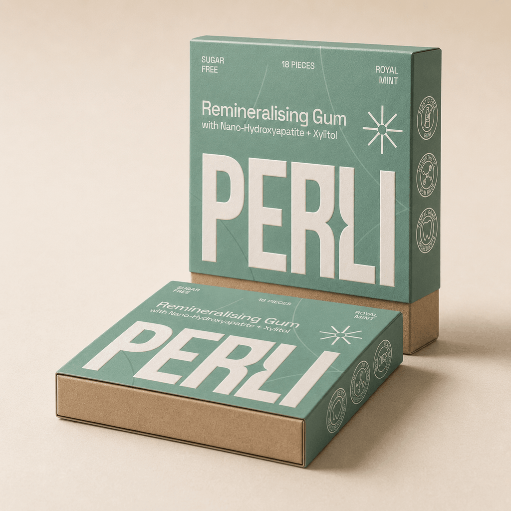 Two Perli Royal Mint gum boxes stacked on stone surface